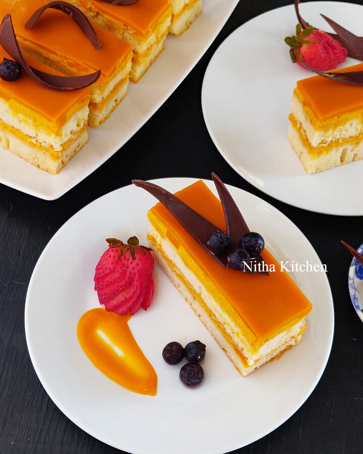mango dessert, fusion mango dessert, how to make mango mousse cake, how to make mango mousse cake from scratch, mango mousse cake recipe, mango mousse with cake cookie base, mango mousse cake with mango glaze recipe, Mango Recipes, nitha kitchen cakes and bakes, nitha kitchen eggless baking recipes, nitha kitchen mango recipes, single serve mango dessert recipe, vanilla sponge cake filled with mango mousse , double layered vanilla cake with mango mousse filling, mango mousse filling for cakes, how to make chocolate strands, how to make chocolate triangle, chocolate decorations as cake topper, cake topper ideas, chocolate decoration ideas, mango mousse cake recipe, mango mousse cake, mango mousse cake video recipe, mango mirror glaze, mango glaze recipe, royal mango dessert, fusion mango dessert ideas
