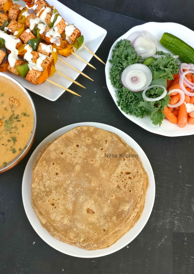 You may not need dry flour while rolling the chapati if dough is too soft then sprinkle it.
So roll the chapatis to medium thin, neither too thick nor too thin (Pic 3).
Heat the dosa pan tawa and the pan should heat well in high temperature.
Once done add the rolled chapati, it puffs up well (Pic 4 and 6) flip it so the other side also cooks as well.
If your chapati is not puffing up that might because of the thickness you rolled out, nothing to worry when you see golden spots then you can flip it over.
If using dry flour then using wet kitchen towel wipe the excess flour while cooking as shown in the video.
Repeat the above process till you done with all uncooked chapati.