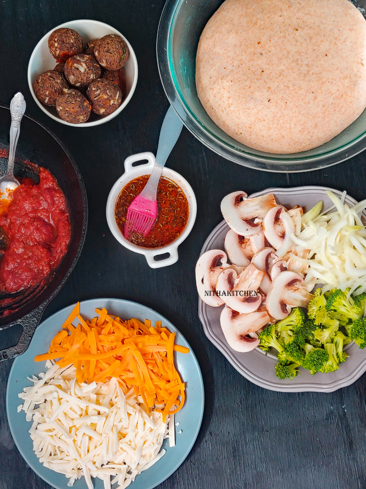 Whole wheat Pizza with vegetarian topping like beans meatless meat kofta balls , mushroom, broccoli and onion